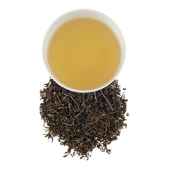 Harney & Sons brewed jasmine pouchong in a cup on a table showing calming enjoyment
