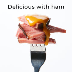 Hickory Farms glaze brushed on ham, creates glossy savory-sweet finish