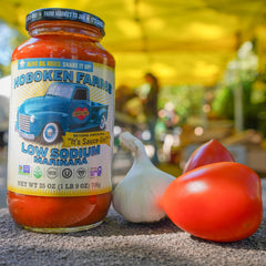 Hoboken Farms pouring sauce over pasta for a quick meal
