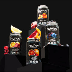 Humm Acai Blueberry can with berries and leaves showing real-ingredient freshness benefit