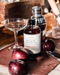 Jack Rudy syrup being poured into a cocktail adding depth and flavor benefit