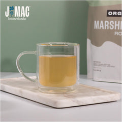 J Mac Botanicals loose marshmallow root scattered on tabletop highlighting organic origin