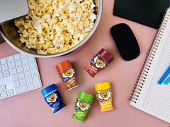 Kernel Season's popcorn poured with seasoning for flavorful immediate use