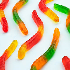 Kervan scattered pile of mixed-color gummy worms showing variety and appeal