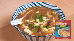 Kikkoman hot and sour egg flower soup served in a bowl with egg ribbons and garnish for quick warmth