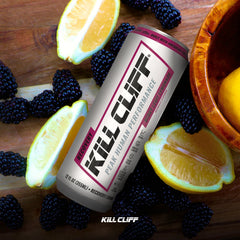 Kill Cliff can held by hand near gym gear showing on-the-go recovery and portable hydration benefit