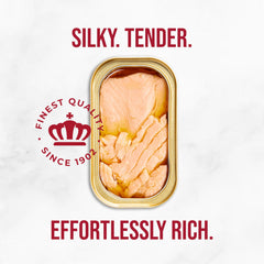 Close-up of King Oscar salmon flakes highlighting moist texture and premium quality