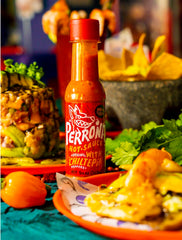 La Perrona pouring onto taco adding bold chiltepin heat and flavor lift