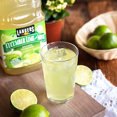 Langers in a glass with cucumber slices in a kitchen setting, serving a cool beverage