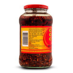 LAO GAN MA spoon drizzling over noodles providing immediate savory boost