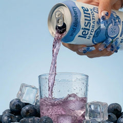 Leisure can held by a hiker outdoors showing portable electrolyte refreshment and adaptogen benefits