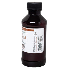 Pouring a few drops of LorAnn flavor into a spoon to show strong dosage control