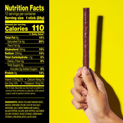 Lorissa's Kitchen stick held in a hand to show 1 oz size and portable protein benefit