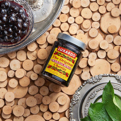 luxardo cherries in syrup on spoon demonstrating syrup texture benefit: ready-to-serve sweetness
