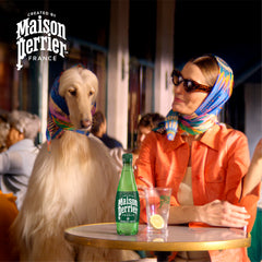 Maison Perrier bottle in hand showing portable 16.9 fl oz size benefit