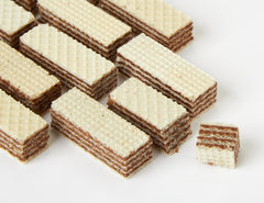 Manner wafers beside coffee cup in lifestyle scene highlighting enjoyable pairing
