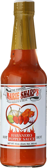 Marie Sharp's bottle front showing bright orange-red sauce and label, vivid flavor benefit