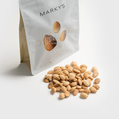 MARKY'S Marcona almonds in a ceramic bowl served on a charcuterie board for entertaining