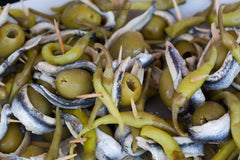Matiz peppers on charcuterie board adding tangy accent to cheeses