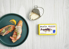 Matiz close-up of olive oil texture bathing cod, highlighting moist preservation