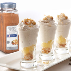 Spoon scooping McCormick Culinary pumpkin pie spice from container, enables fast portioning