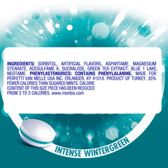 MENTOS wintergreen next to keys to show compact bottle size and portability