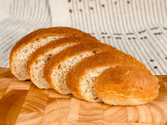 Sliced Molibake potato loaf on cutting board showing soft texture and usable slices