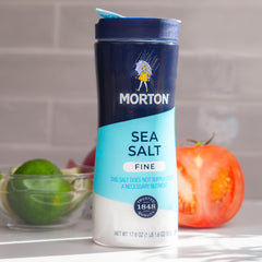Morton shakers seasoning a grilled steak to enhance flavor quickly and evenly