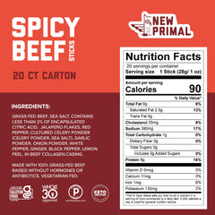 Single individually wrapped New Primal spicy beef stick held in hand, demonstrates portable high-protein snack