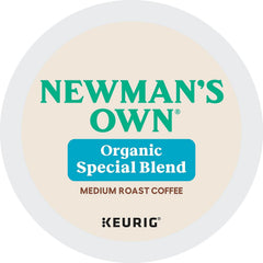 Newman's Own K-Cup next to a hand for scale showing compact, portable portion control