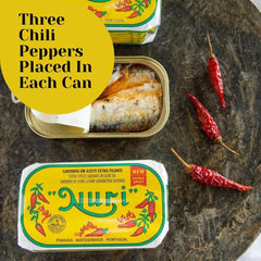 Nuri open can overhead revealing spiced sardines in olive oil