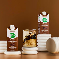 nutpods carton beside coffee cup for scale and convenient single-serve benefit