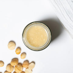 Nutural World spoonful of macadamia butter showing creamy crunch and convenient serving benefit