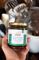 Offcuts Kitchen spoon adding demi-glace into a pan sauce for instant depth and gloss