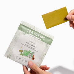 Olyxir single tea strip close-up dissolving to reveal instant infusion benefit