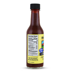 Organic Harvest chipotle-habanero sauce pouring onto grilled dish for smoky savory boost