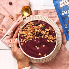 Paleonola ingredients spread with nuts, seeds, coconut and dried blueberries for transparency