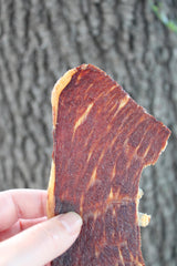 PHILLIPS BEEF CRISPS next to a ruler for scale to show compact portion size