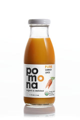 Pomona Organic bottles held in hand showing 8.4 oz scale and easy grab-and-go benefit