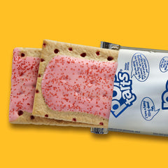 Hand holding a Pop-Tarts Frosted Cherry to show size and easy portability
