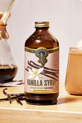 Portland Syrups pouring into a coffee cup adding smooth vanilla sweetness