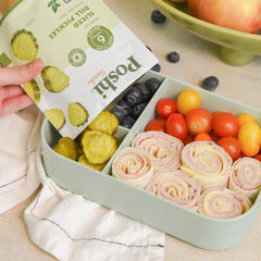 Poshi hand holding pouch illustrating on-the-go convenience