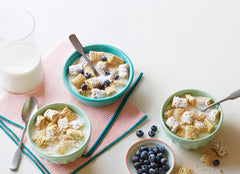 Post shredded wheat poured from open box into bowl for quick breakfast
