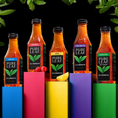 Pure Leaf bottle on picnic table with glass, highlighting refreshment