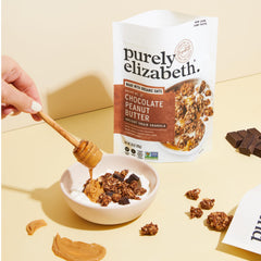 purely elizabeth granola sprinkled on yogurt with berries for a nutritious bowl