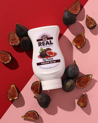 Reàl Infused Exotics pouring into a cocktail, adding natural fig flavor and depth