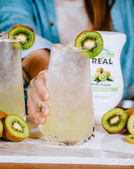 Reàl Infused Exotics mango syrup being poured, adds bold tropical mango flavor