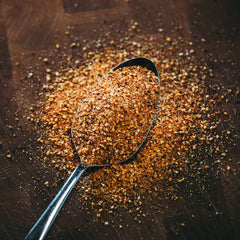 recteq seasoning being applied to raw ribs to boost flavor before smoking