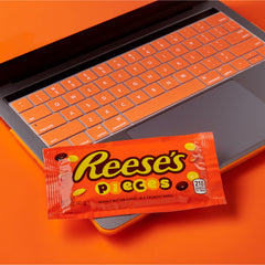 Reese's bag beside a hand for scale illustrating the 1.53-ounce single-serve size