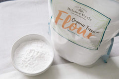 Relative Foods wooden scoop with tapioca flour illustrating portion and volume
